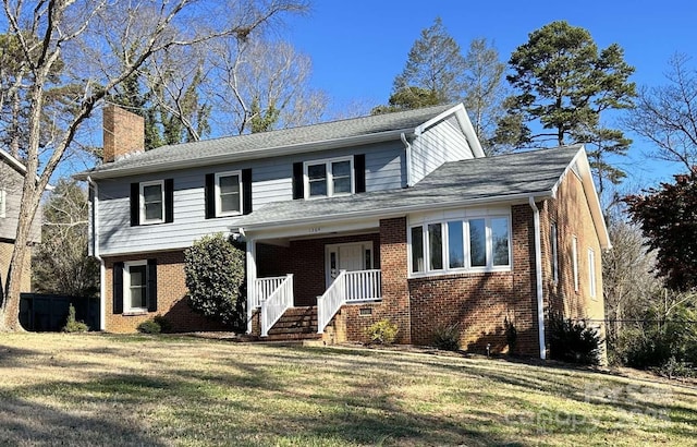 front of property with covered porch and a front yard