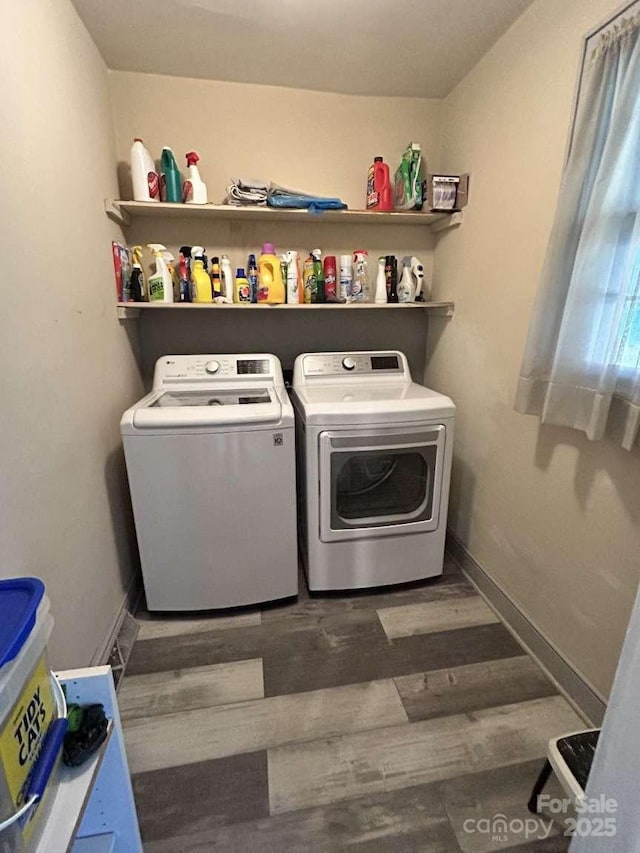 washroom with dark hardwood / wood-style floors and independent washer and dryer