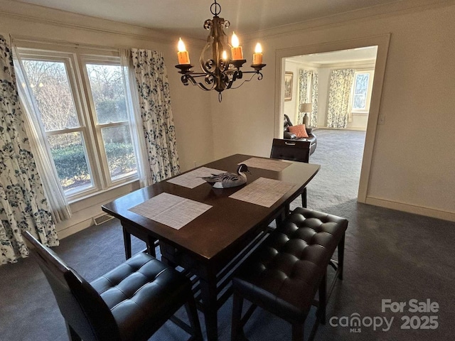 dining area with dark carpet, a notable chandelier, and crown molding