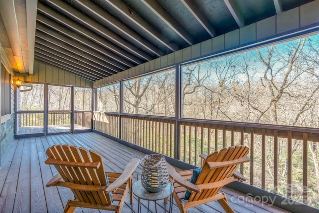 unfurnished sunroom with vaulted ceiling