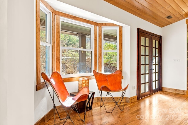 sitting room with french doors, light hardwood / wood-style flooring, and wood ceiling