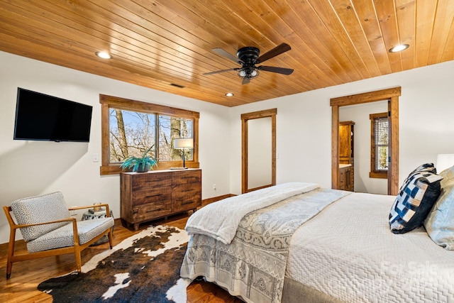 bedroom featuring wood ceiling, connected bathroom, ceiling fan, and wood-type flooring