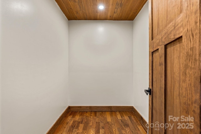 interior space featuring dark wood-type flooring and wooden ceiling