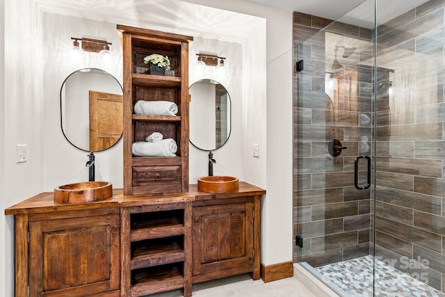 bathroom with an enclosed shower and sink