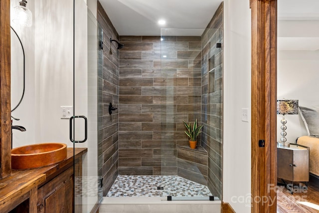 bathroom with vanity and a shower with door