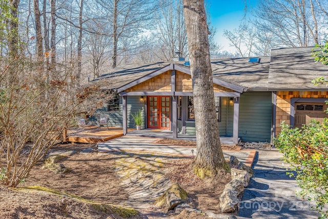 exterior space with a porch and a garage