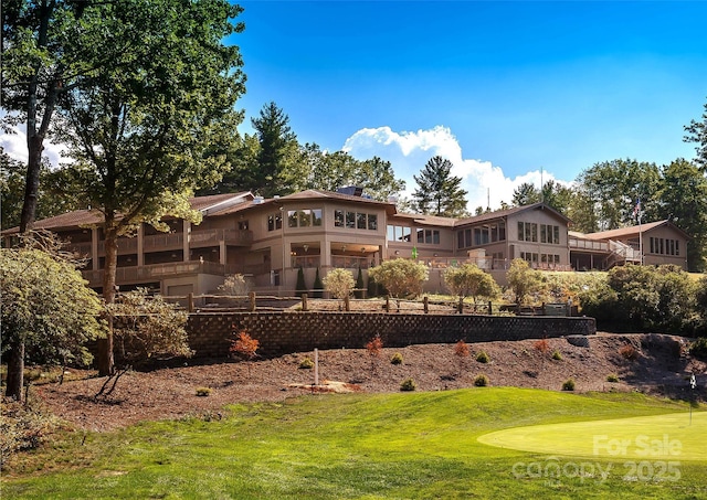 rear view of property with a lawn