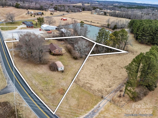 birds eye view of property featuring a water view and a rural view