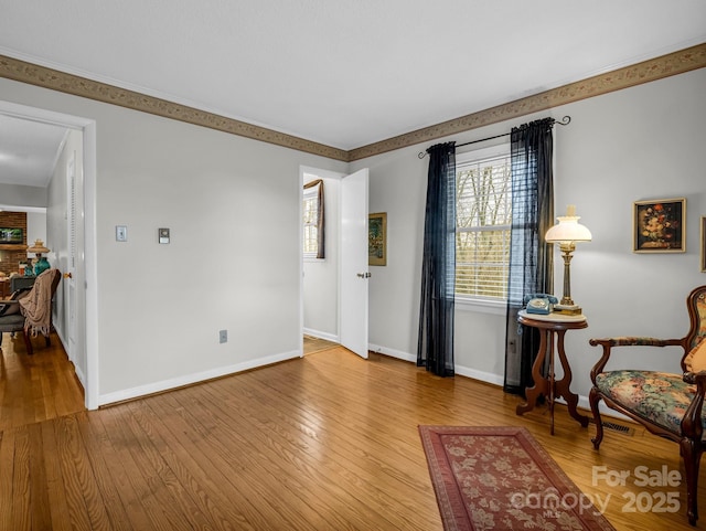 sitting room with wood-type flooring