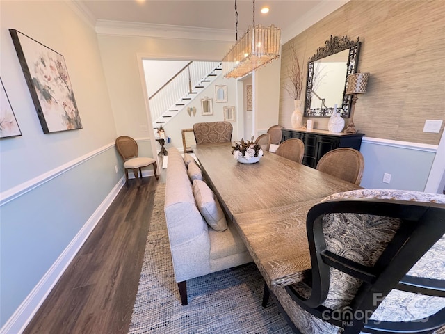 dining space featuring a notable chandelier, dark hardwood / wood-style flooring, and ornamental molding