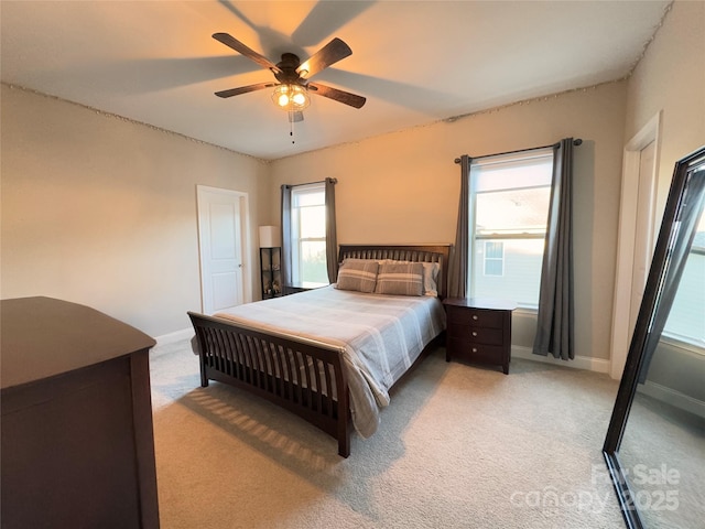 bedroom featuring light colored carpet and ceiling fan