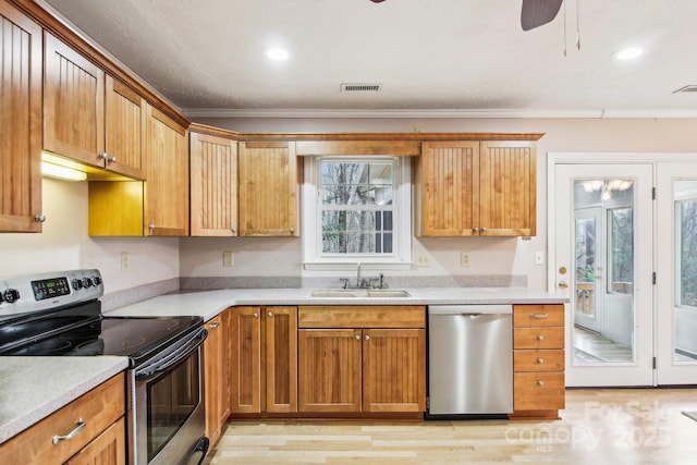 kitchen with stainless steel appliances, ceiling fan, ornamental molding, and sink