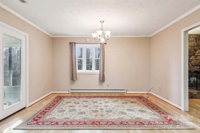 dining space with a notable chandelier, a baseboard heating unit, crown molding, a textured ceiling, and hardwood / wood-style flooring