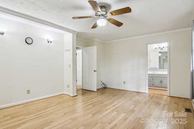 unfurnished bedroom with ceiling fan, ornamental molding, light hardwood / wood-style flooring, and ensuite bath