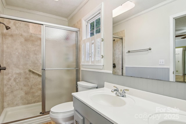 bathroom featuring crown molding, vanity, an enclosed shower, and toilet