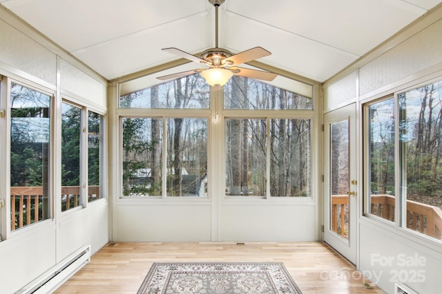 unfurnished sunroom featuring a wealth of natural light, ceiling fan, vaulted ceiling, and a baseboard heating unit