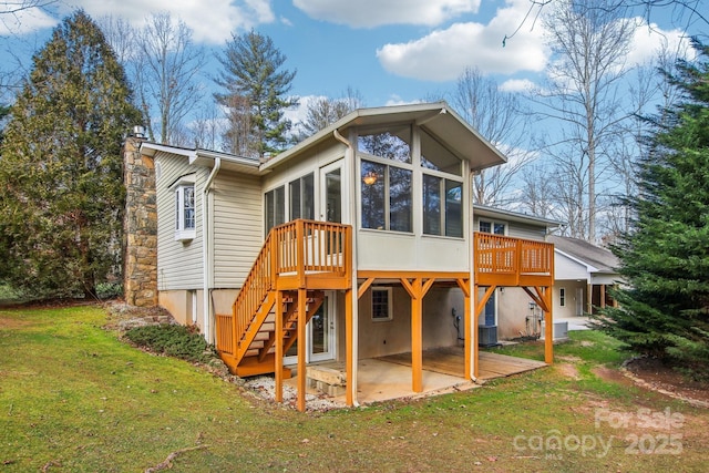 rear view of property with a sunroom, a yard, a deck, central air condition unit, and a patio