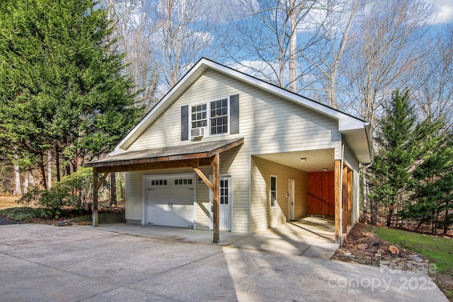 view of front of property with a garage, a carport, and cooling unit