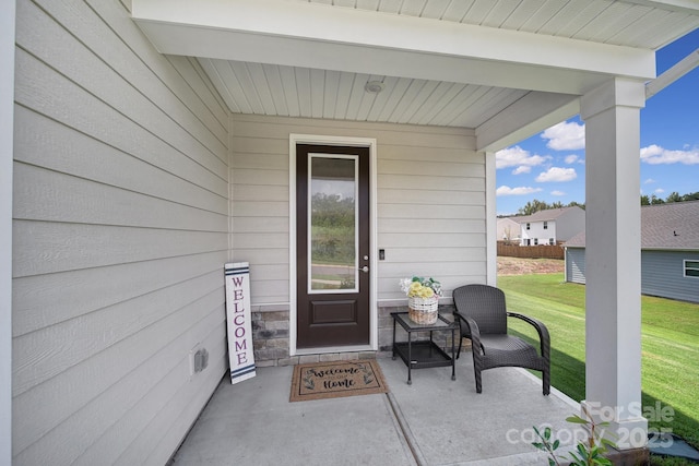 property entrance with a yard