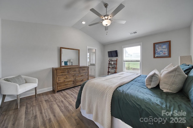 bedroom featuring hardwood / wood-style flooring, ceiling fan, vaulted ceiling, and ensuite bath