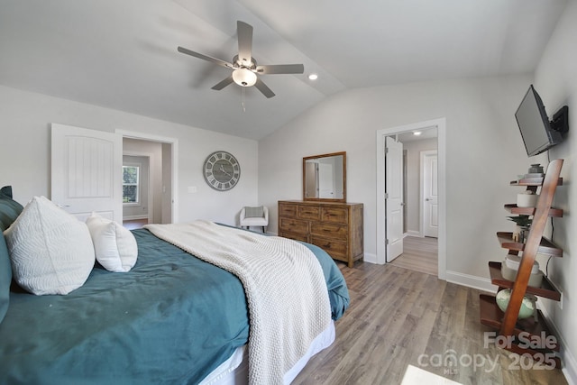 bedroom with vaulted ceiling, light hardwood / wood-style flooring, and ceiling fan