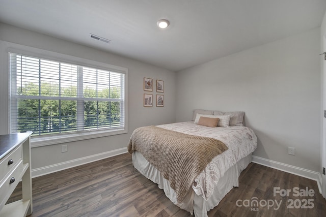 bedroom with dark wood-type flooring