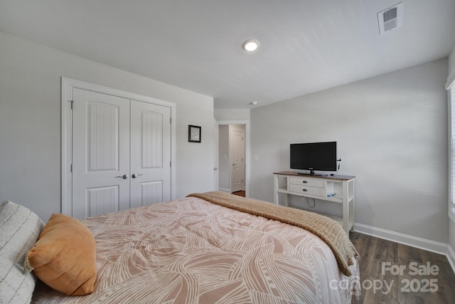 bedroom featuring dark hardwood / wood-style flooring and a closet