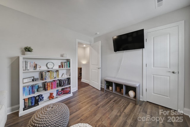 sitting room featuring dark wood-type flooring