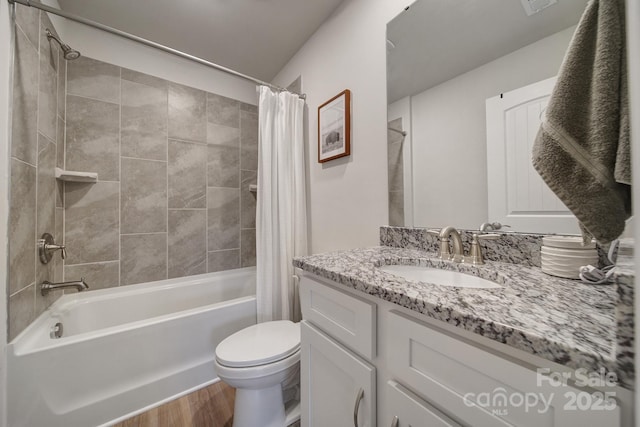 full bathroom featuring toilet, hardwood / wood-style floors, vanity, and shower / tub combo with curtain