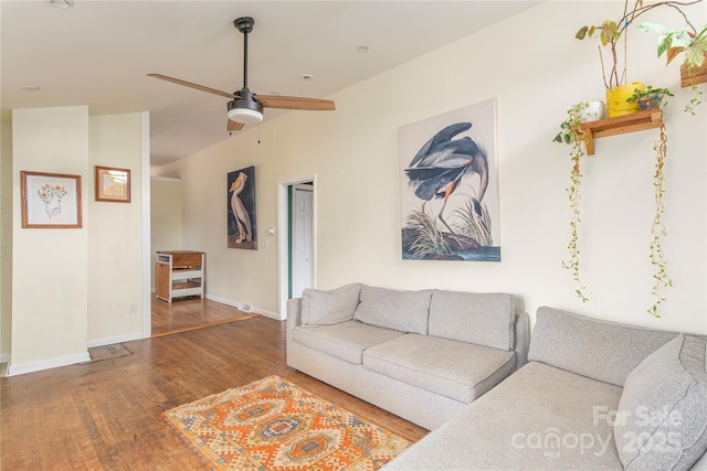 living room featuring ceiling fan, hardwood / wood-style floors, and vaulted ceiling