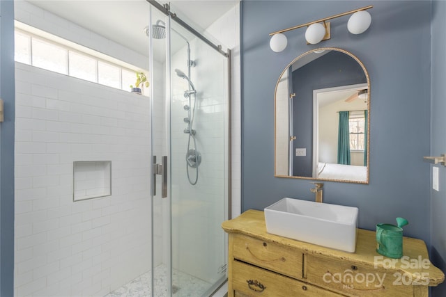 bathroom with vanity and a shower with door