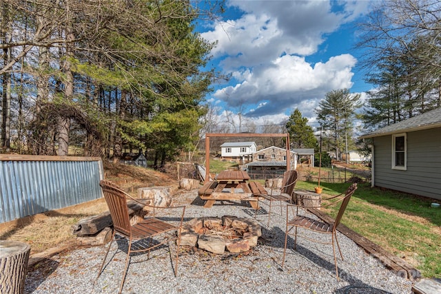 view of patio with an outdoor structure and an outdoor fire pit