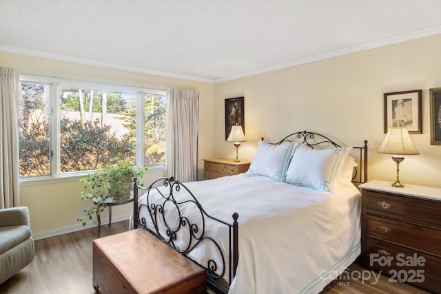 bedroom with multiple windows, crown molding, and light hardwood / wood-style floors