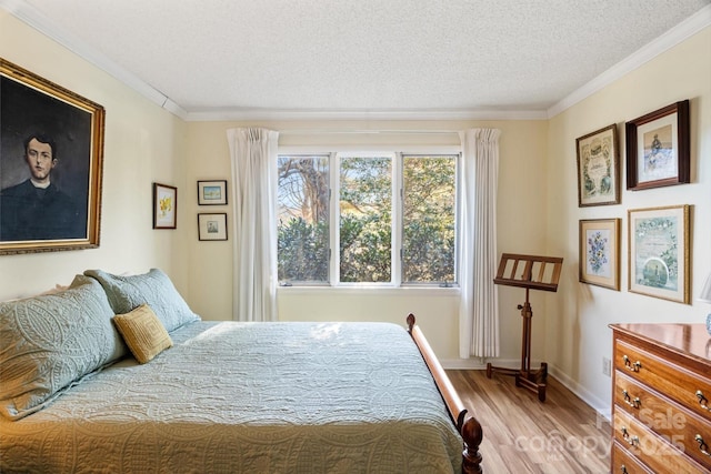 bedroom featuring crown molding, light hardwood / wood-style floors, multiple windows, and a textured ceiling