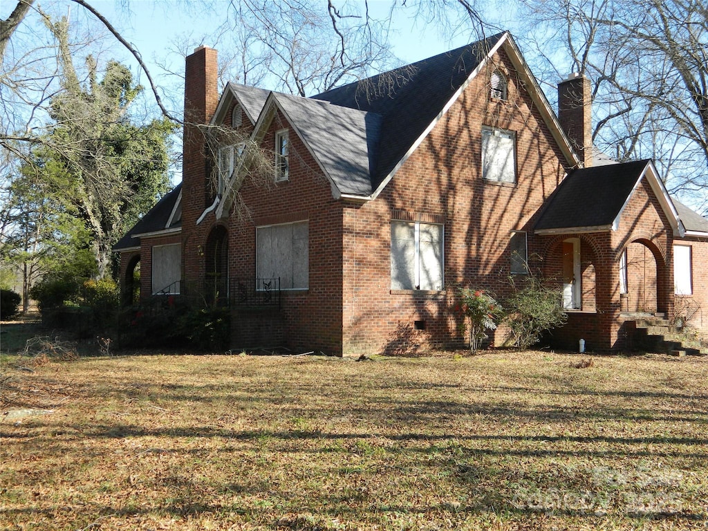 view of property exterior featuring a lawn