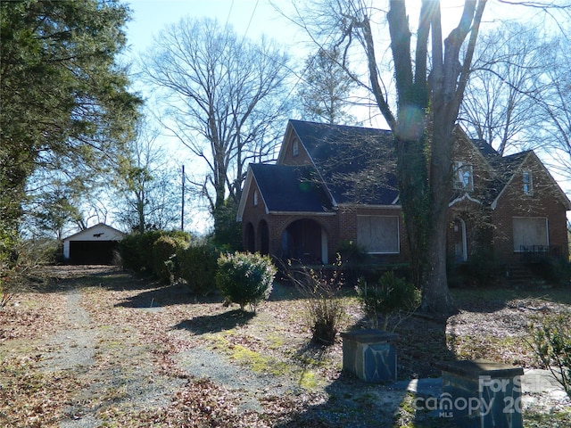 view of side of property with a garage and an outdoor structure