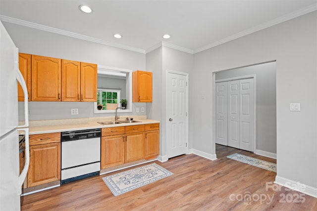 7019 Walnut Ridge Ct, Charlotte, NC 28217 - kitchen featuring white appliances, a sink, light wood-style floors, crown molding, and light countertops