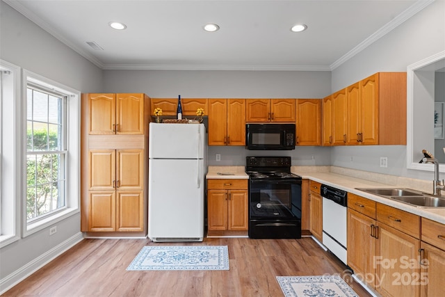 7019 Walnut Ridge Ct, Charlotte, NC 28217 - kitchen with black appliances, a sink, light wood-style flooring, light countertops, and ornamental molding