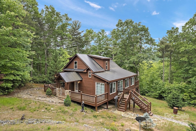 rear view of property featuring a deck