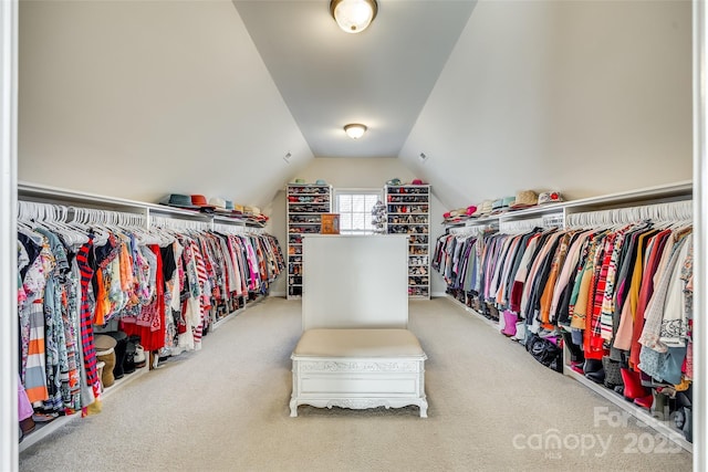 walk in closet featuring carpet flooring and lofted ceiling