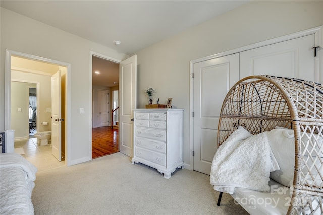 bedroom with light colored carpet and a closet