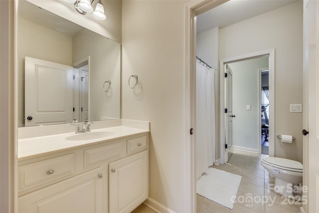 bathroom featuring toilet, vanity, and tile patterned floors