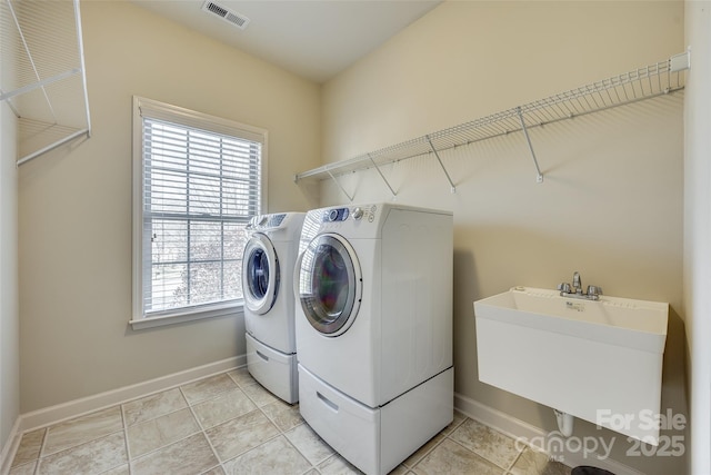 washroom featuring sink and washing machine and clothes dryer