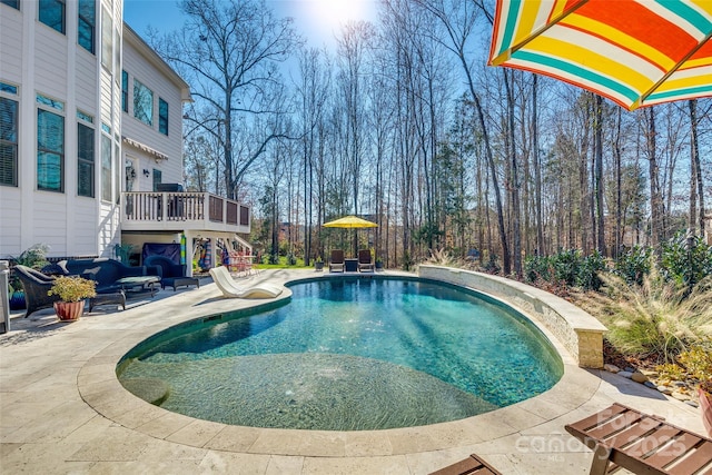 view of pool with a patio and a wooden deck