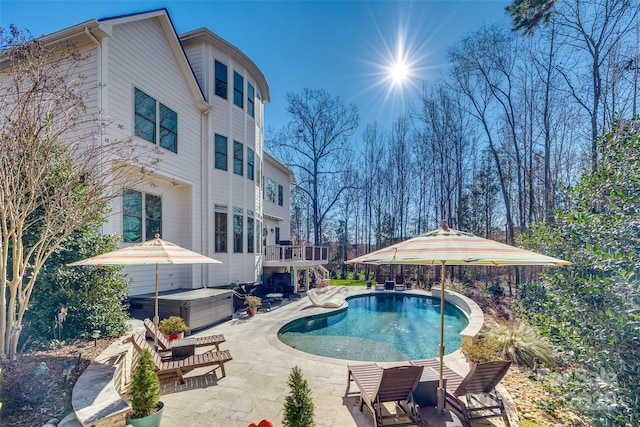 view of pool featuring a hot tub and a patio area