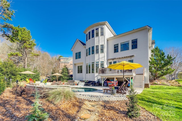 back of house with a patio area and a yard