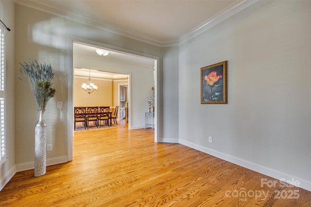 interior space featuring crown molding, light hardwood / wood-style flooring, and a chandelier