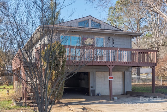 view of front of home featuring a deck and a garage