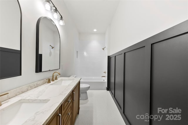 full bathroom with vanity, toilet, and tiled shower / bath combo