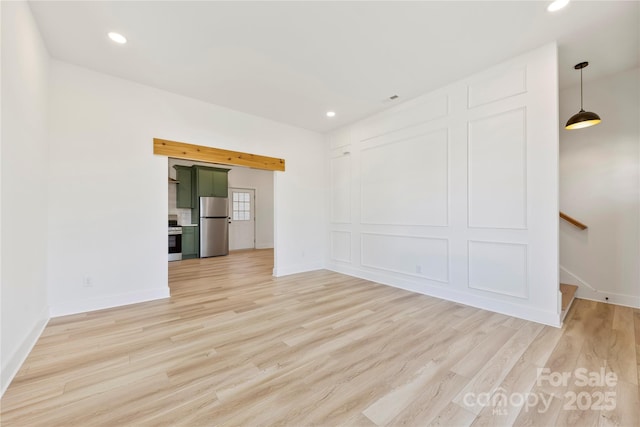 unfurnished room with light wood-type flooring